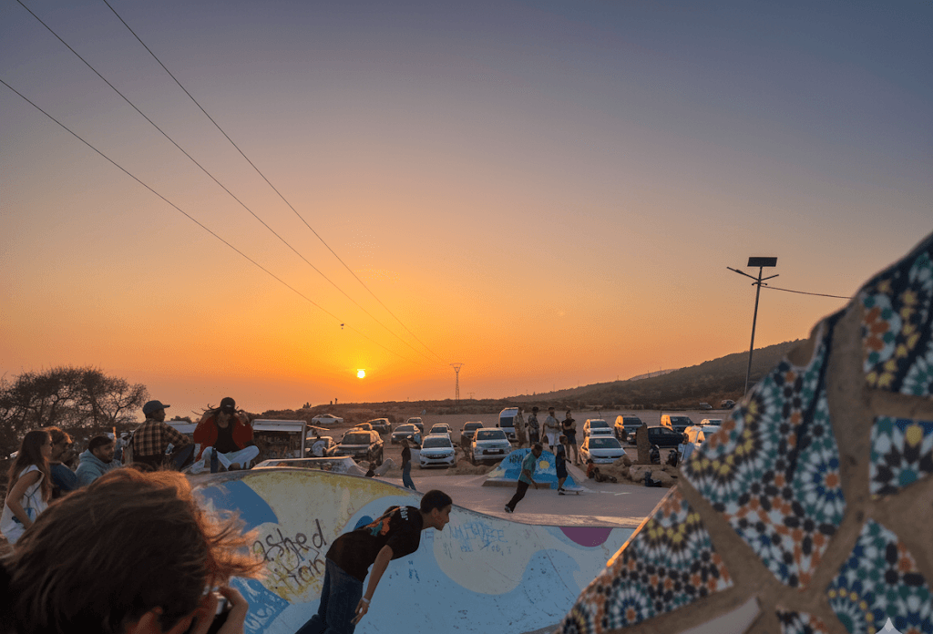 taghazout skate park skater and men take photos during sunset in taghazout 